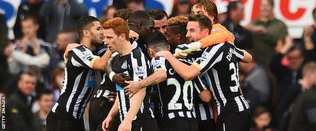 Newcastle players celebrate taking the lead against Liverpool