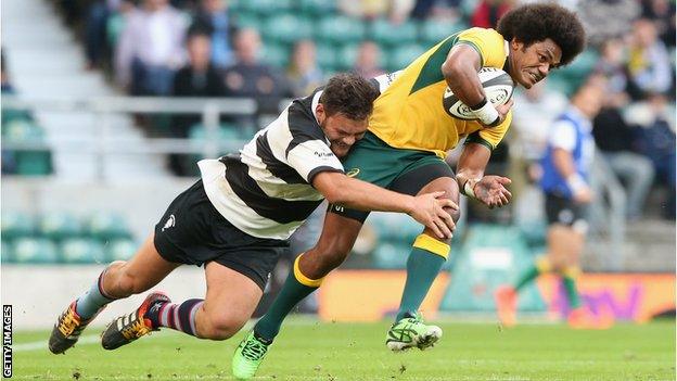 Henry Speight of Australia is tackled by Angus Ta'avao as the Barbarians come close at Twickenham