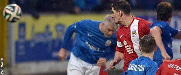 Jimmy Callacher heads in Linfield's winner in the Premiership match at Glenavon