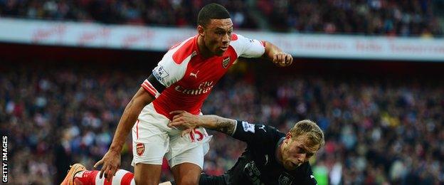 Alex Oxlade-Chamberlain is tackled by Burnley's Scott Arfield