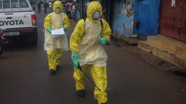 Sierra Leone health workers walk in central Freetown, Sierra Leone on 24 October 2014