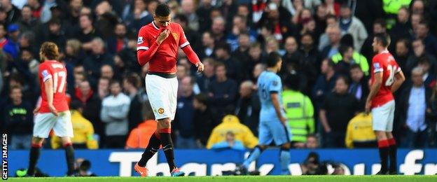 Chris Smalling walks off after being sent off in the Manchester derby