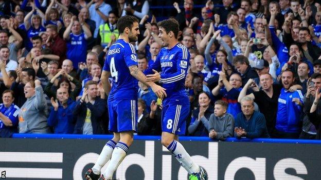 Chelsea players Cesc Fabregas (left) and Oscar celebrate a goal in the game against QPR