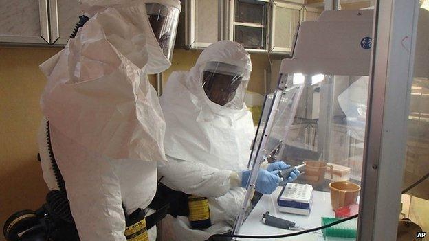 Workers testing in an Ebola lab.