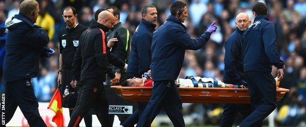 Marcos Rojo is stretchered off at the Etihad Stadium