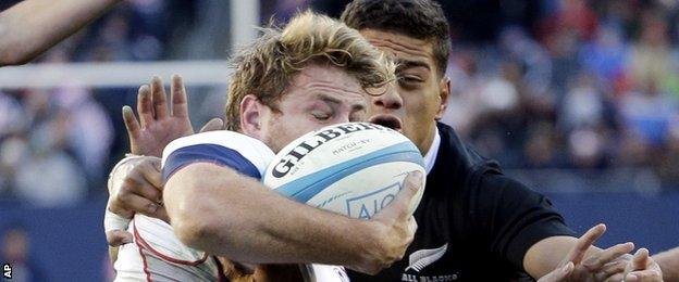 USA's Tom Coolican is tackled by All Blacks' Augustine Pulu