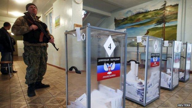 A pro-Russian separatist stands guard at a polling station in Telmanove, south of Donetsk. Photo: 2 November 2014