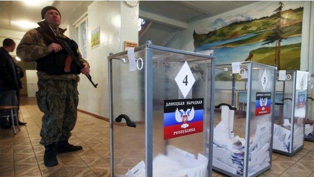 A pro-Russian separatist stands guard at a polling station in Telmanove, south of Donetsk. Photo: 2 November 2014