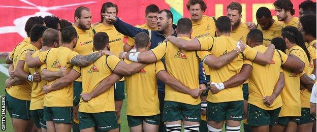 Wallabies form a circle before playing the Barbarians with coach Michael Cheika in the middle