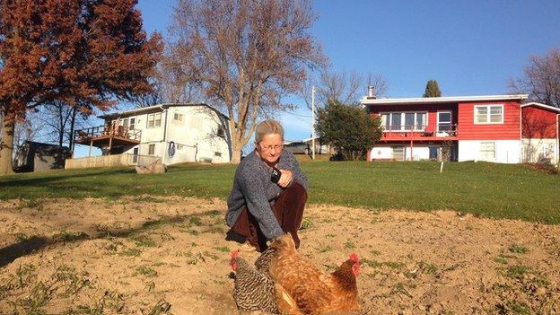 Pauline Hampton with her chickens at Holiday Lake, Iowa