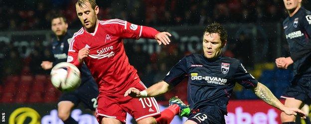 Aberdeen's Niall McGinn challenges Ross County defender Darren Barr