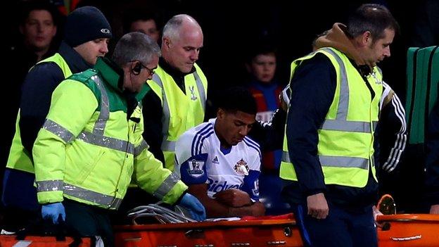 Sunderland defender Patrick van Aanholt is carried from the field