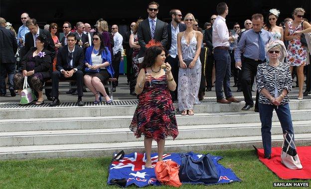 Woman eating on an Australian flag towel at Randwick Racecourse