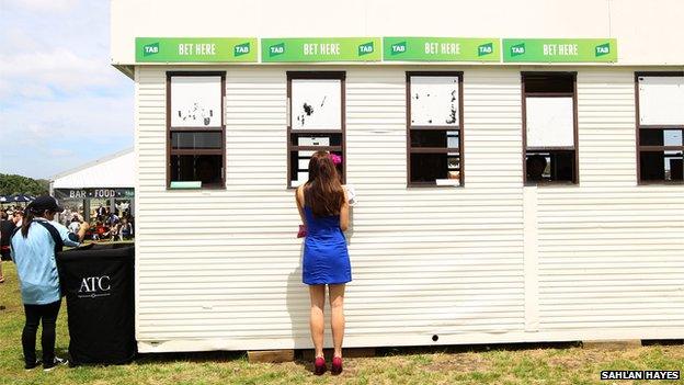 Woman at betting kiosk