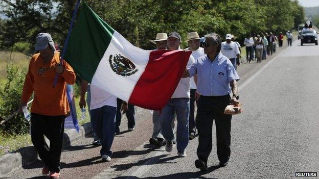 People protest calling for information on 43 missing students along a highway near Iguala, on 3 November 2014