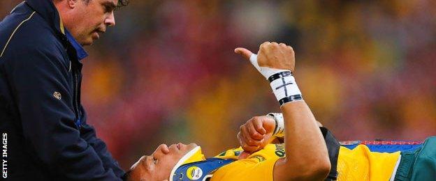 Christian Leali'ifano gives the thumbs up as he's carried off on a stretcher