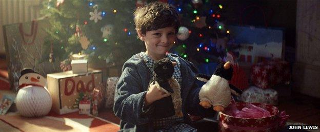 Boy with two penguin toys