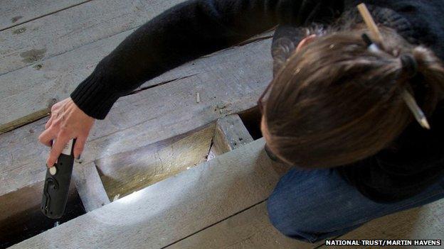 National Trust archaeologist Nathalie Cohen examines witchmarks at Knole