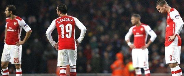 Arsenal players react after conceding a 3-0 lead against Anderlecht in the Champions League