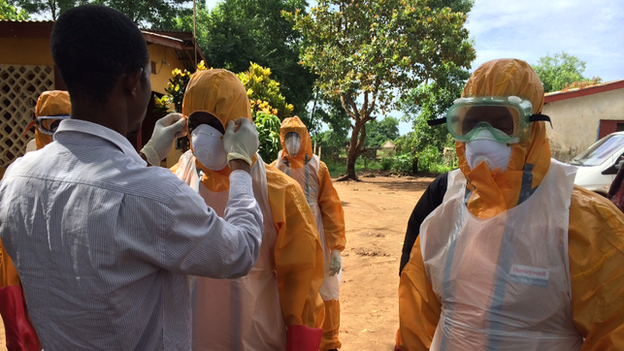 A burial team in Sierra Leone suits up in their protective gear