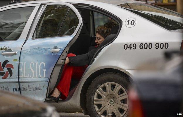 Maria Bamieh leaves a taxi in Pristina (31 Oct)