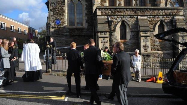 The singer's coffin is led into the church