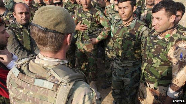 British soldiers instruct Kurdish Peshmerga fighters during training at a shooting range in Arbil on October 18 2014