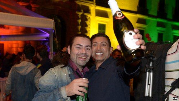 Two men celebrate as the Maltese parliament approves same sex civil unions in April 2014