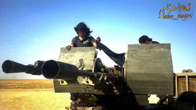 A young jihadist fighter operates heavy artillery in the desert