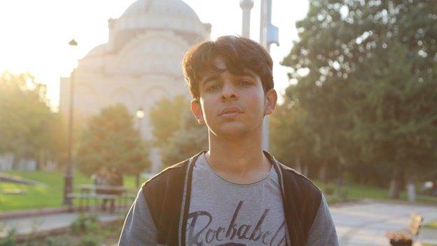 Mohamed, the brother of two young jihadists stands in front of a mosque