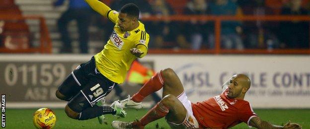 Kelvin Wilson fouls Andre Gray to concede a penalty