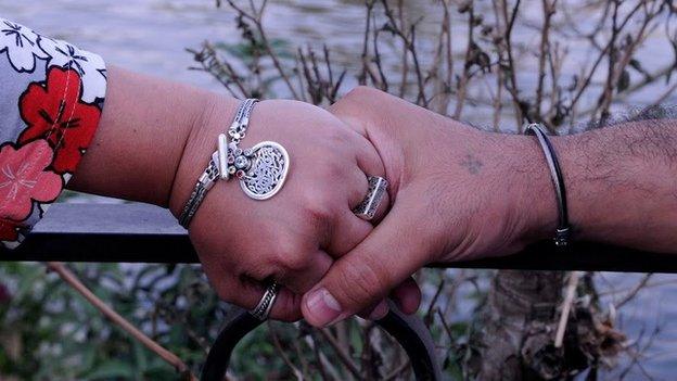 An Egyptian couple hold hands