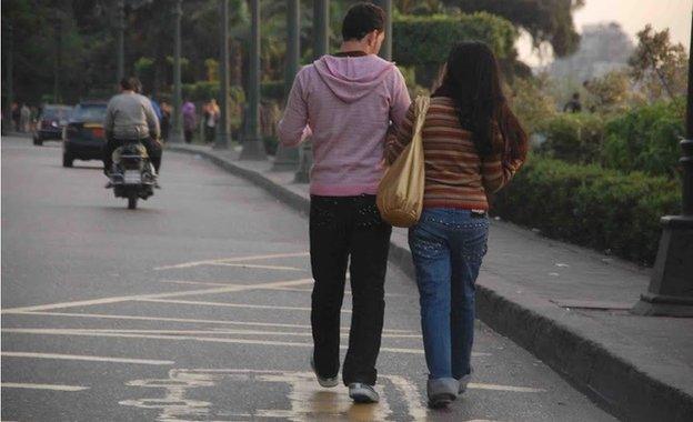 An Egyptian couple walk down the street