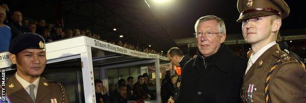 Two soldiers from Aldershot garrison with then Manchester United manager Sir Alex Ferguson in 2011