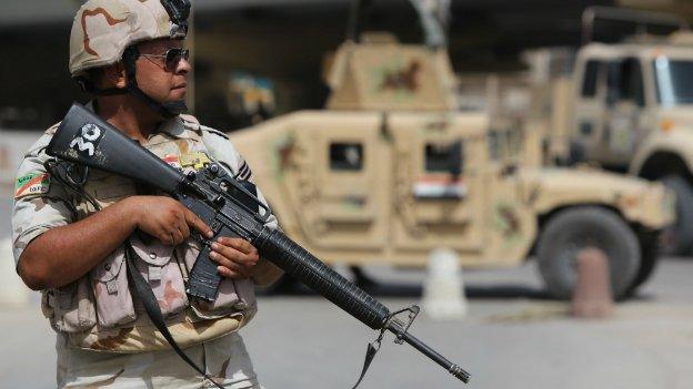 An Iraqi soldier stands guard on a street corner in Iraq's capital Baghdad - 25 September 2014