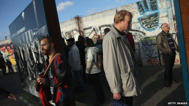 People stand by a remaining section of the Wall - 9 November