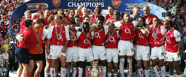 Arsenal players celebrate winning the Premier League in May 2004