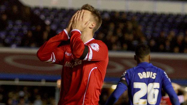 Cardiff City player Anthony Pilkington holds his head in despair