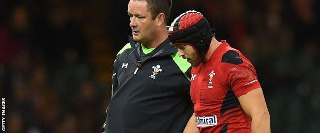 Leigh Halfpenny is led off the field against Australia.