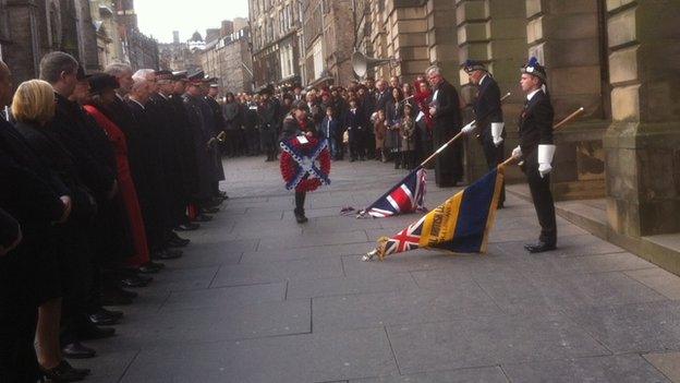 Meghan Mathews placing the wreath at the service in Edinburgh.