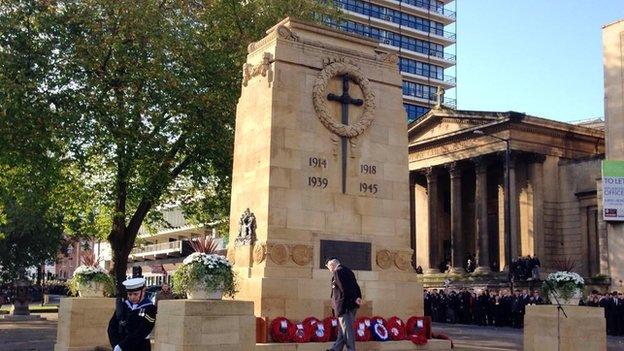 A veteran stops to observe the wreaths at Bristol Cenotaph.