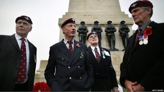 Veteran members of the Guards Parachute Company Pathfinders stand by the Guards Memorial in Horse Guards