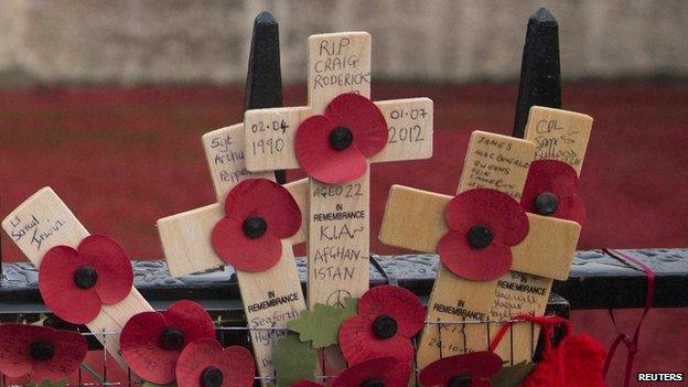 Crosses placed on fence outside Tower of London poppy artwork