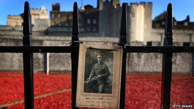 A photograph of Corporal Thomas William Belton of the Kings Shropshire Light Infantry, who died in Belgium in World War One at the age of 25, is placed on railings surrounding the "Blood Swept Lands and Seas of Red" installation