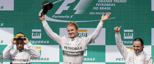 First runner up Mercedes Formula One driver Lewis Hamilton of Britain, winner Mercedes Formula One driver Nico Rosberg of Germany and second runner up Williams Formula One driver Felipe Massa of Brazil react during the podium ceremony after the Brazilian Grand Prix in Sao Paulo November 9, 2014