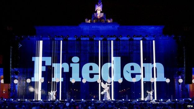 The word peace is projected on to the Brandenburg Gate, Berlin. 9 Nov 2014