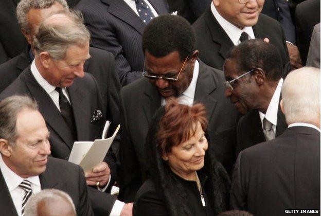 Prince Charles, the Prince of Wales, shakes hands with Zimbabwe's President Robert Mugabe during Pope John Paul II's funeral in St. Peter's Square on 8 April 2005 in Vatican City.