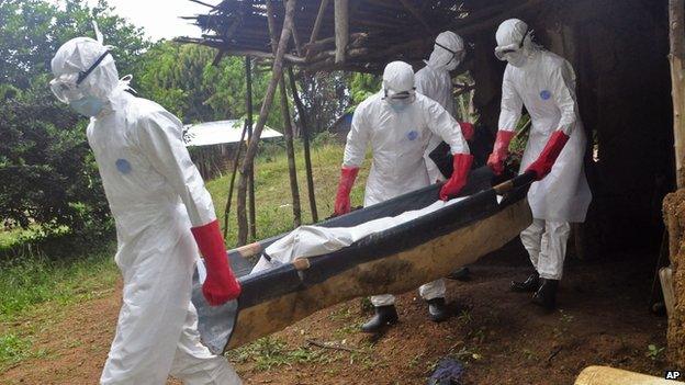 A man, thought to have died from Ebola, is carried from his home