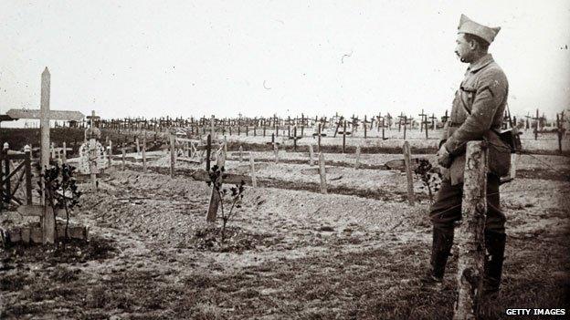 A French soldier looking at graves