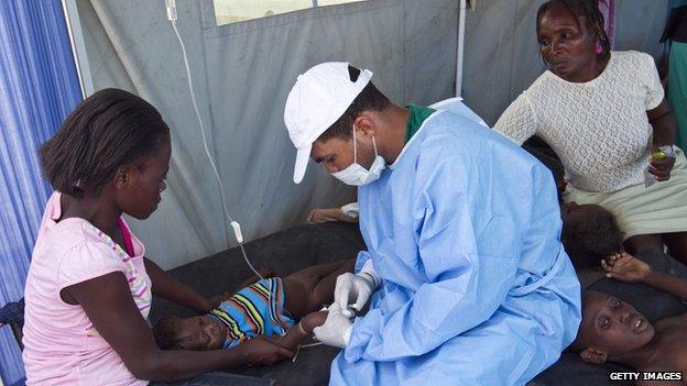 A Cuban doctor treats a patient at a hospital in L'Estere, Haiti on 26 October, 2010